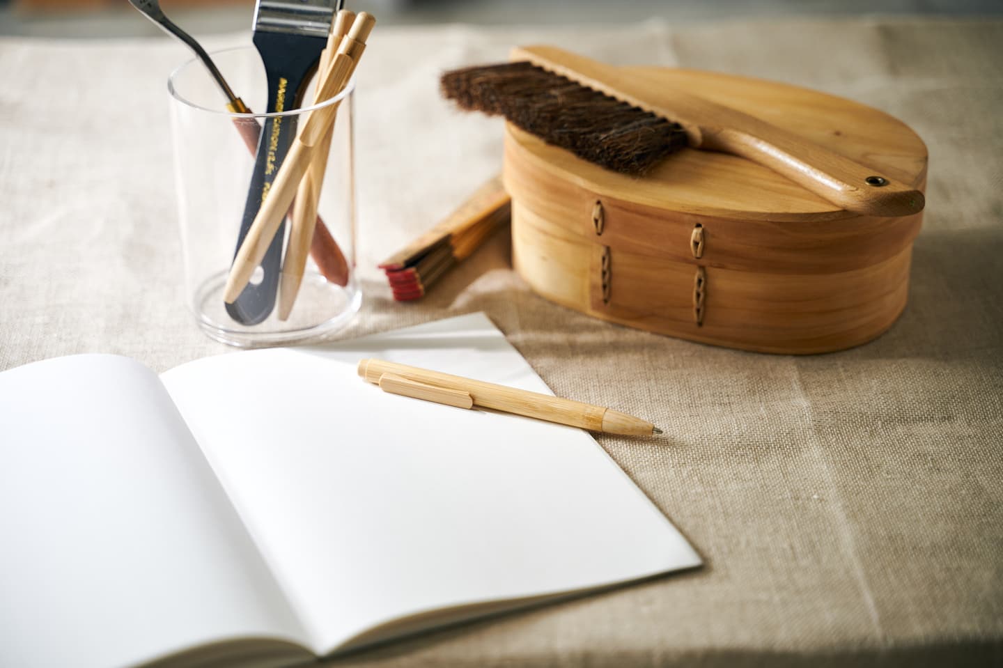 大阪のスタジオで撮影された、柔らかな光が差し込むアトリエの風景。木製のペンやノート、道具箱を配した、クリエイティブな日常を想起させるライフスタイル撮影